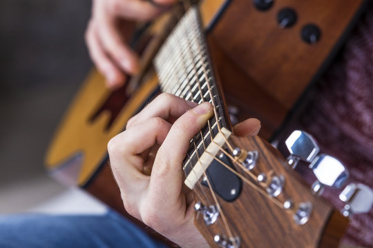 detail of fingers and hand of guitar player