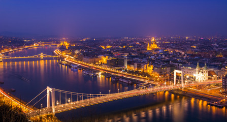 Fototapeta na wymiar Cityscape view of Budapest capital in evening lights, bridge and landmarks illuminated in Hungary