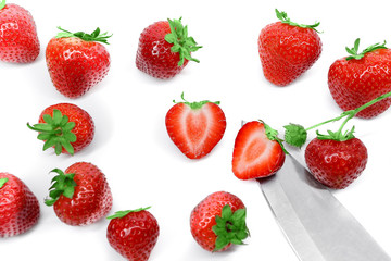 Strawberries and knife isolated on white background