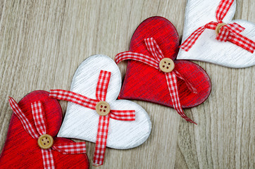 Wooden background with red and white hearts.