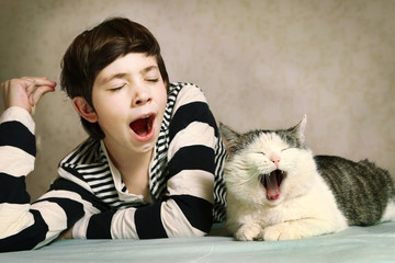  boy in striped blouse and siberian cat