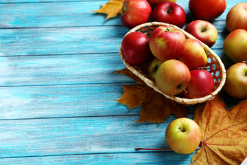 Fresh apples on a blue wooden table