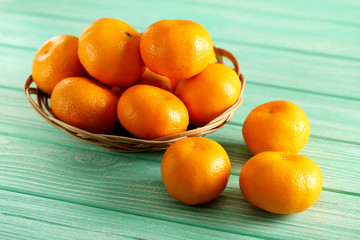 Ripe mandarins on a mint wooden table