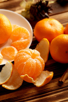 Ripe mandarins on a brown wooden table