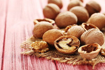Walnuts on a red wooden table