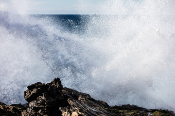 Wave Crashing on Rocky Coast