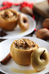 Baked apples on plate on grey wooden table