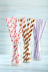 Drink straws on a blue wooden background