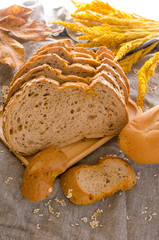 Loaf of sliced bread on wooden background