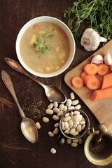 Bean soup in a bowl with fresh herbs