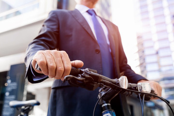 Successful businessman riding bicycle