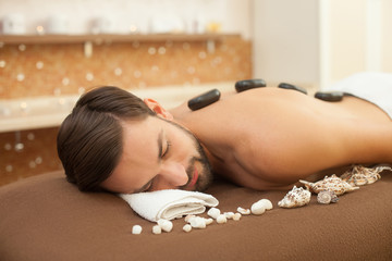 Cheerful young guy is resting at beauty salon