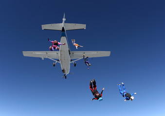 Skydiving group of people jumping from the plane