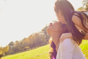 Lifestyle portrait mom and daughter in happines at the outside in the meadow
