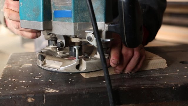 Joiner handles milling machine wooden parts for furniture