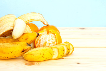 Bananas, mandarines on wooden table