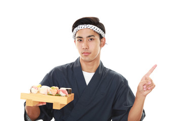 指示する笑顔の寿司職人