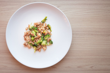 Stir-Fried Broccoli with pork on white dish top view