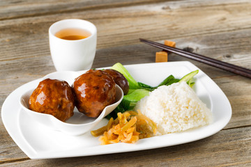 Saucy meatballs meal in white plate ready to eat
