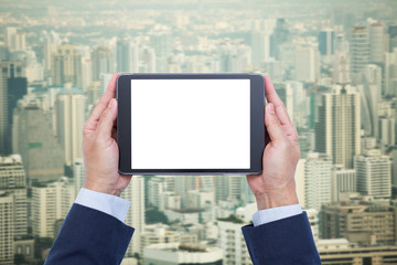 Businessman hands holding blank screen digital tablet on citysca