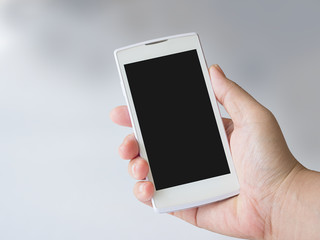 Human hand holding blank mobile smart phone