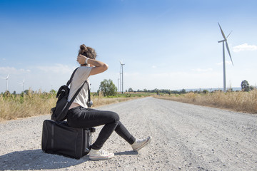 young girl traveling with bag waiting for bus