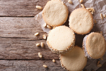 Fototapeta na wymiar Tasty cookies with cream on paper. Horizontal top view 
