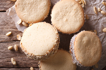 Tasty cookies with cream on paper close-up. Horizontal top view
