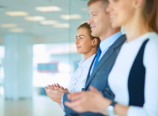 Smiling business people applauding a good presentation in the office