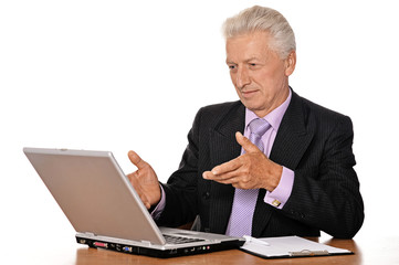 Mature businessman working with laptop