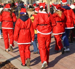 people dressed as Santa Claus during the race in the city