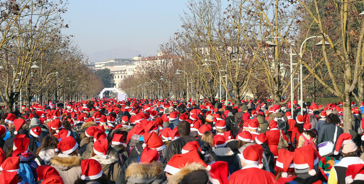 of people dressed as Santa Claus during the foot race
