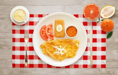 Breakfast with egg omelet, cheese, chutney sauce, tomato. Fruit dessert.