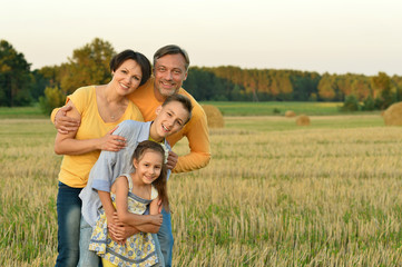 Naklejka na ściany i meble Happy family in wheat field