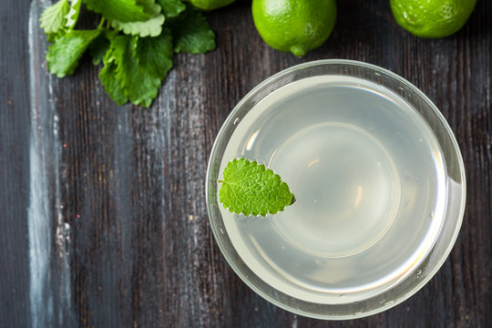 Cocktail margarita with limes and mint on the rustic background