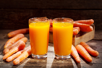 glasses of carrot juice with fresh vegetables