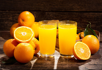 glasses of orange juice with fresh fruits