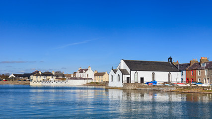 Fototapeta premium Isle of Whithorn Waterfront. The view across Isle of Whithorn Bay to the small coastal village of Isle of Whithorn in Dumfries and Galloway, Southern Scotland.
