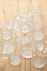 group of glasses and glass jars on wooden board