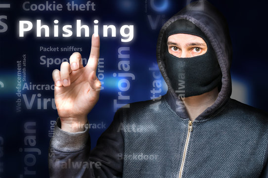 Masked anonymous hacker is pointing on Phishing