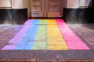 Pride colors painted on sidewalk in front of entrance