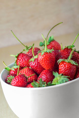 Strawberries in a Bowl, on a wooden background