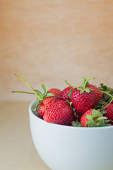 Strawberries in a Bowl, on a wooden background