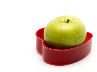 Green apple in heart box, concept for love, isolated on white ba