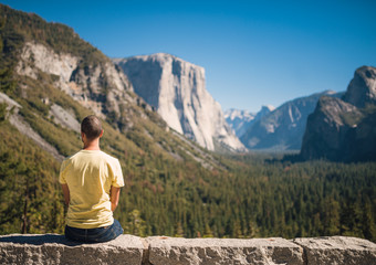 Travel in Yosemite Park, man Hiker with backpack enjoying view, California, USA, caucasian