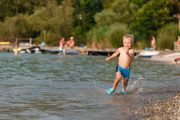 Fototapeta premium Little boy running water.