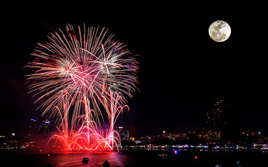 Fireworks celebration with super moon in the city