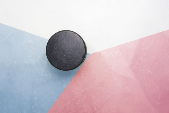 old hockey puck is on the ice with czech republic flag