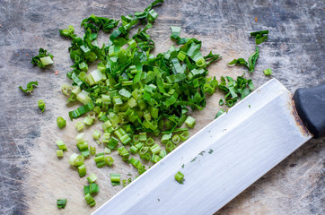 Close up knife and vegetable on wooden block