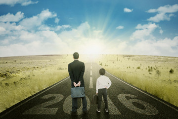 Businessmen with numbers 2016 on the road